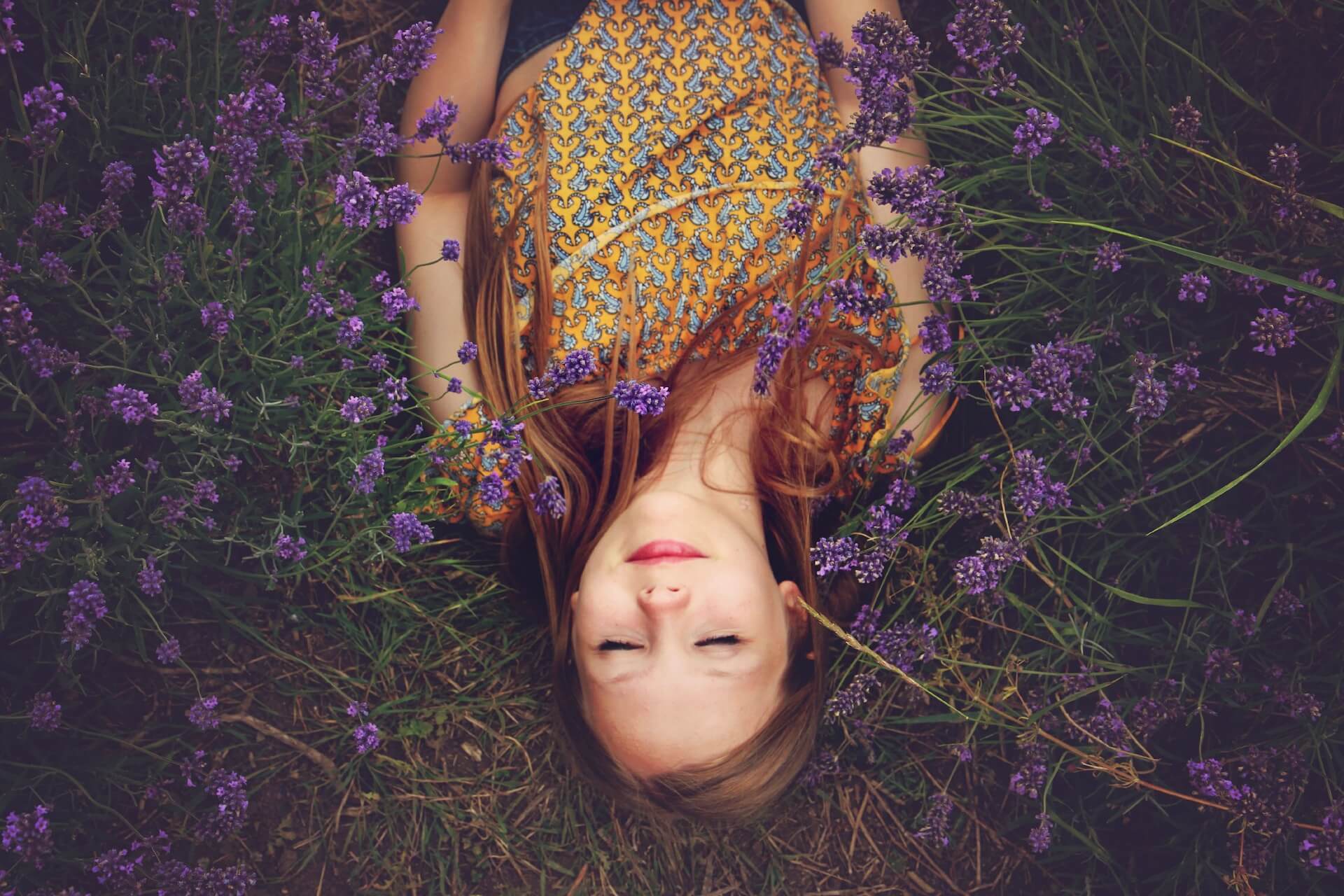 femme allongée les yeux fermés dans l'herbe